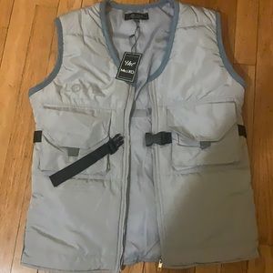 Gray vest with black straps. Medium in size never Ben worn